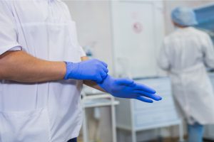 doctor-wearing-latex-gloves-medicine-and-health-PSTFYD5